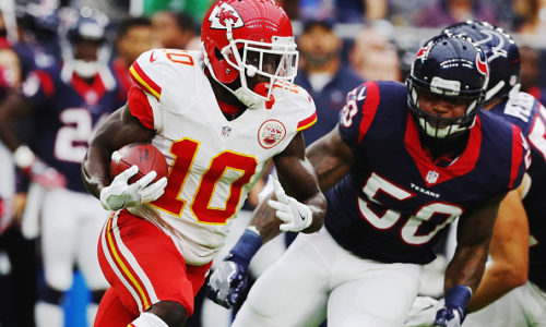 HOUSTON, TX - SEPTEMBER 18: Tyreek Hill #10 of the Kansas City Chiefs runs away from the tackle of Akeem Dent #50 of the Houston Texans in the first quarter of their game at NRG Stadium on September 18, 2016 in Houston, Texas. (Photo by Scott Halleran/Getty Images)
